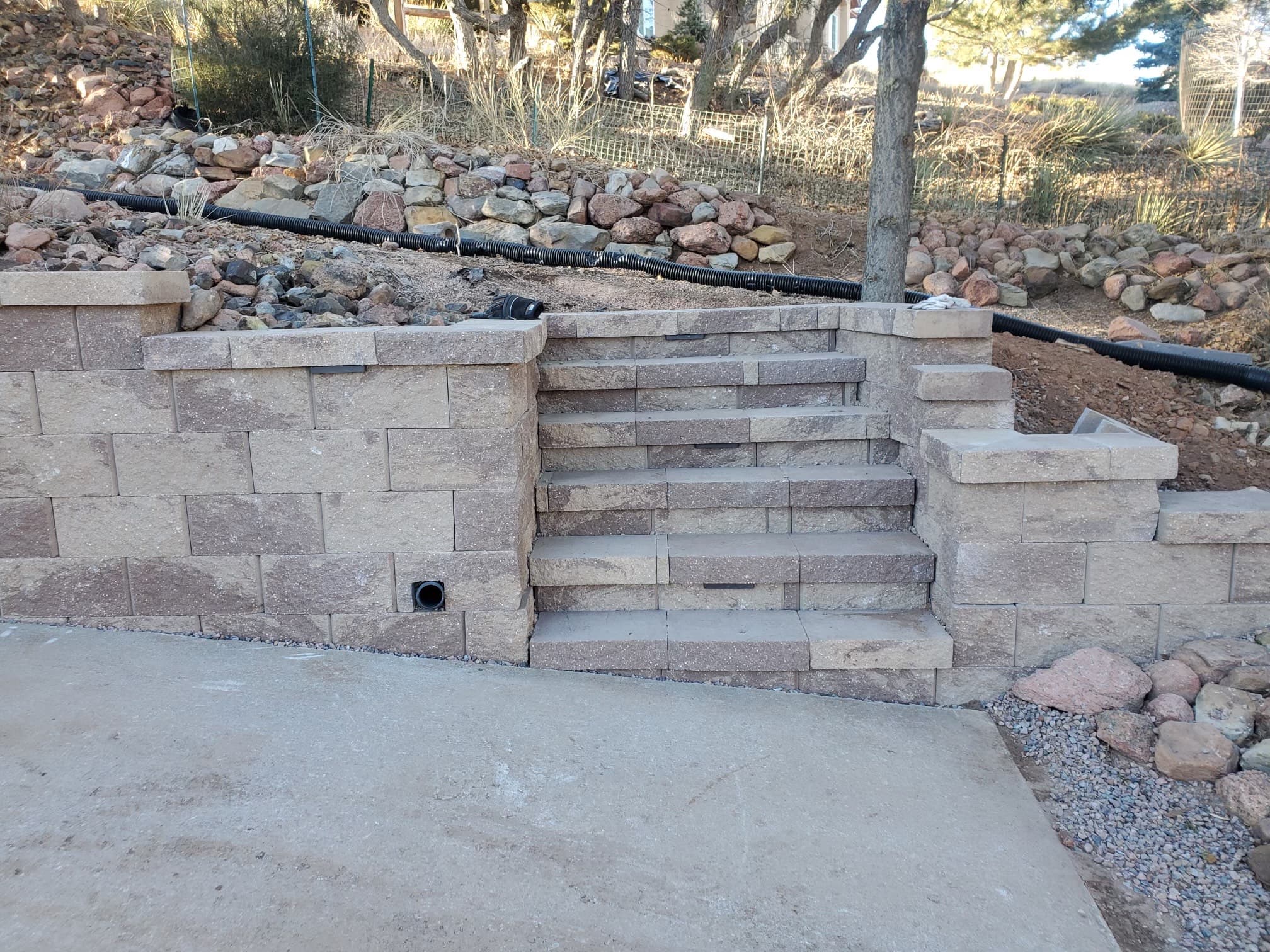 Retaining wall with stone steps and drainage